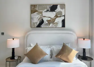 a bedroom with a white bed with two lamps at Livbnb - 2BR Apartment with Breathtaking Marina View in Dubai