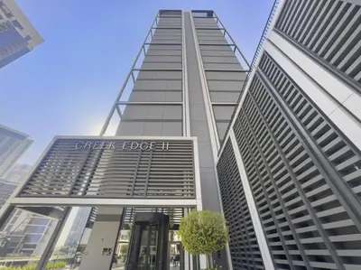 a tall building with a sign on the side of it at Luxury 1BR apartment at Creek Edge Tower 2 in Dubai