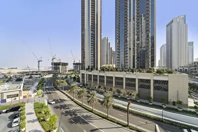 a city with tall buildings and a street with cars at Luxury 1BR apartment at Creek Edge Tower 2 in Dubai