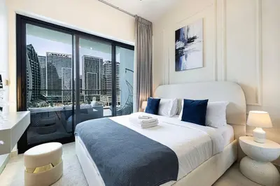 a bedroom with a large bed and a large window at Lux Apartment with huge private Lounge I Burj & Canal View in Dubai