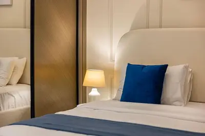 a bedroom with a blue pillow on a bed at Lux Apartment with huge private Lounge I Burj & Canal View in Dubai