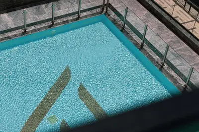 an overhead view of a blue swimming pool at Lux Apartment with huge private Lounge I Burj & Canal View in Dubai