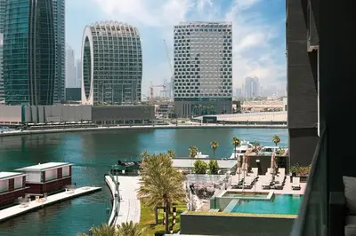 a view of a city with a river and buildings at Lux Apartment with huge private Lounge I Burj & Canal View in Dubai