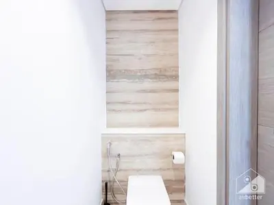 a bathroom with a toilet and a wooden wall at High End 1Bedroom with Balcony & View Dubai in Dubai