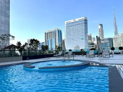 a large swimming pool on the roof of a building at Modern Furnished Studio with Canal View , High Floor in Dubai
