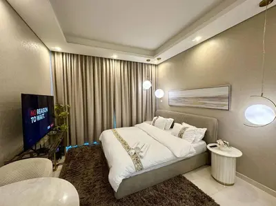 a bedroom with a large bed and a television at Modern Furnished Studio with Canal View , High Floor in Dubai
