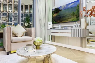 a living room with a couch and a coffee table at Burj Khalifa View 2BR Steps from Dubai Mall & Metro in Dubai