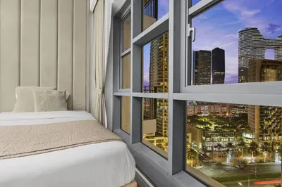a bedroom with a window with a city view at Burj Khalifa View 2BR Steps from Dubai Mall & Metro in Dubai