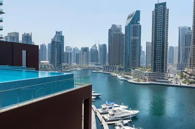 a view of a river with boats in a city at Jumeirah Living Marina Gate - Golf & Skyline Views with Pool & Gym in Dubai