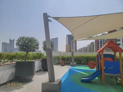 a play area with a slide and a playground at Savis Homes - Azizi Riviera 43 - Chic Studio Near Downtown and Business Bay in Dubai