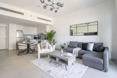 a living room with a couch and a table at Frank Porter - Lamtara 3 in Dubai