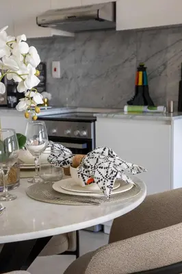 a table in a kitchen with a plate of food at Frank Porter - Lamtara 3 in Dubai