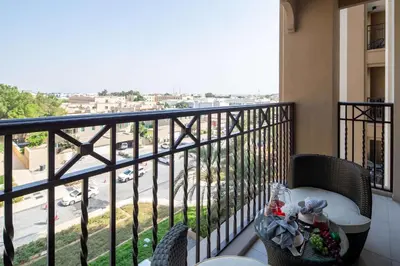 a balcony with a table and chairs and a view of a street at Frank Porter - Lamtara 3 in Dubai
