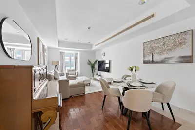 a living room with a dining table and a living room at Cozy 1-Bedroom Apartment In Princess Tower in Dubai