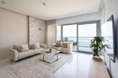 a living room with a couch and a table at Frank Porter - The One JBR in Dubai