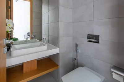 a bathroom with a white sink and a toilet at Frank Porter - The One JBR in Dubai