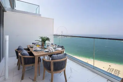 a dining room with a table and a view of the ocean at Frank Porter - The One JBR in Dubai