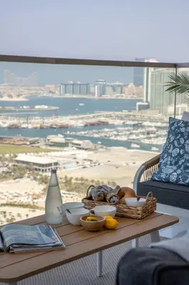 a table with food on it with a view of the beach at Frank Porter - The One JBR in Dubai