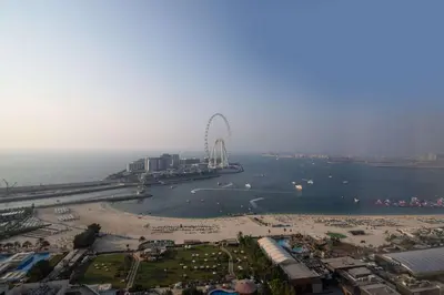 a large ferris wheel in the middle of a body of water at Frank Porter - Shams 4 in Dubai