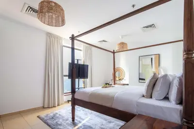 a bedroom with a canopy bed and a television at Frank Porter - Shams 4 in Dubai