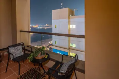 a balcony with chairs and a table with a view at Frank Porter - Shams 4 in Dubai
