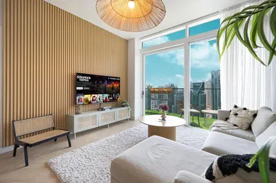 a living room with a couch and a tv at Marina Views in Walkable Location with Pool & Gym in Dubai