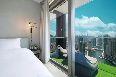 a bedroom with a large window with a view of the city at Marina Views in Walkable Location with Pool & Gym in Dubai