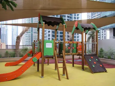 a childrens play area with a playground with slides and slidesktop at Marina Views in Walkable Location with Pool & Gym in Dubai