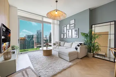 a living room with a white couch and a large window at Marina Views in Walkable Location with Pool & Gym in Dubai