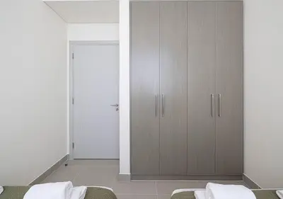 a bedroom with a closet with two beds in it at Downtown Sky High Luxury Apartment I City And Sea Views I Opp Dubai Mall Burj Khalifa in Dubai