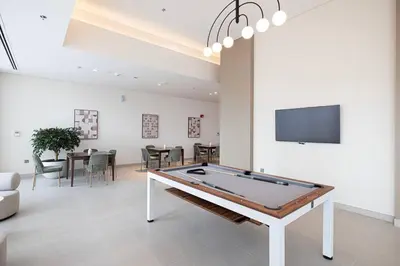 a living room with a pool table and a tv at Downtown Sky High Luxury Apartment I City And Sea Views I Opp Dubai Mall Burj Khalifa in Dubai