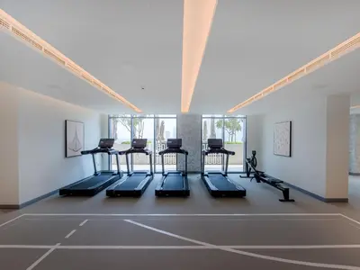 a gym with cardio equipment in a room at Stunning 1 bedroom sea view apartment in Dubai