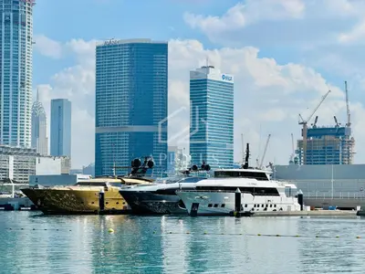 a group of boats docked in the water in a city at Stunning 1 bedroom sea view apartment in Dubai