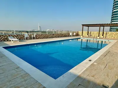 a large blue swimming pool on top of a building at Apartment in Al Barsha1 Near by Metro in Dubai