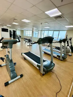 a gym with rows of treadmills and exercise bikes at Apartment in Al Barsha1 Near by Metro in Dubai