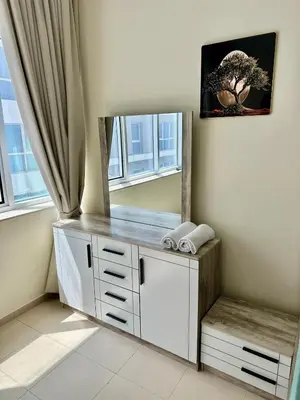 a dressing table in a room with a mirror at Apartment in Al Barsha1 Near by Metro in Dubai