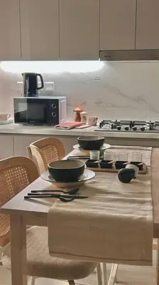 a kitchen with a table with bowls and utensils on it at Cozy urban stay near Dubai Mall in Dubai