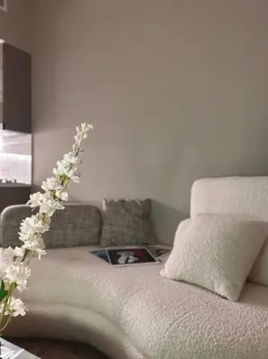 a living room with a couch with a flower arrangement at Cozy urban stay near Dubai Mall in Dubai