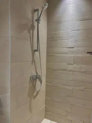 a shower with a glass door in a bathroom at Cozy urban stay near Dubai Mall in Dubai
