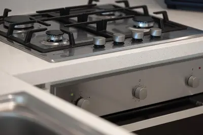 a stove top oven with a sink in a kitchen at Stunning Burj Khalifa Views - Dubai Mall Access - Infinity Pool - MaxStays in Dubai