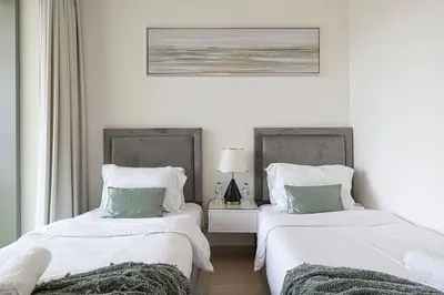 two beds sitting next to each other in a bedroom at Stunning Burj Khalifa Views - Dubai Mall Access - Infinity Pool - MaxStays in Dubai