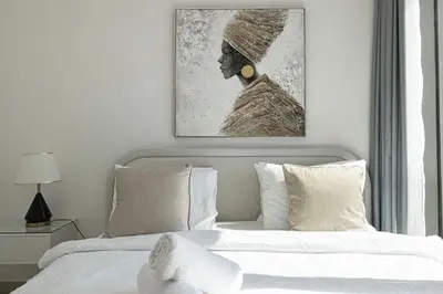 a bedroom with a bed with a picture of a woman at Stunning Burj Khalifa Views - Dubai Mall Access - Infinity Pool - MaxStays in Dubai
