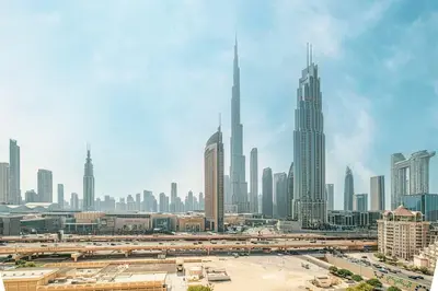 a view of a large city with tall buildings at Stunning Burj Khalifa Views - Dubai Mall Access - Infinity Pool - MaxStays in Dubai
