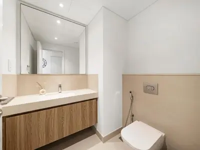 a bathroom with a sink and a toilet and a mirror at Blissful Stays - Luxury Two Bedroom Apartment at Downtown Views II- 5 min walk to Dubai Mall, Burj Khalifa with Infinity Pool in Dubai