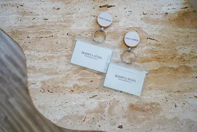 two keychains with the words australias on them at Blissful Stays - Luxury Two Bedroom Apartment at Downtown Views II- 5 min walk to Dubai Mall, Burj Khalifa with Infinity Pool in Dubai