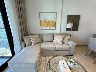 a living room with a couch and a glass table at Stylish 1br Apartment Jvc Balcony Parking in Dubai