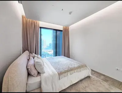 a bedroom with a bed and a large window at FIRST CLASS 1BR Charming City in Dubai