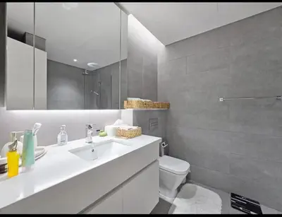 a bathroom with a sink and a toilet and a mirror at FIRST CLASS 1BR Charming City in Dubai