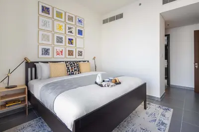 a bedroom with a bed with a stuffed animal on it at Frank Porter - Creek Edge Tower 1 in Dubai