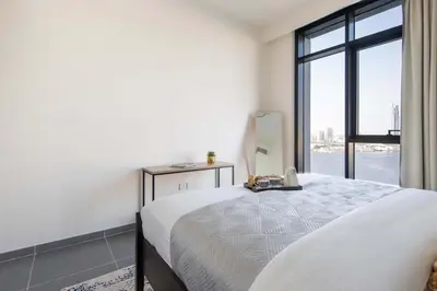 a bedroom with a bed and a large window at Frank Porter - Creek Edge Tower 1 in Dubai